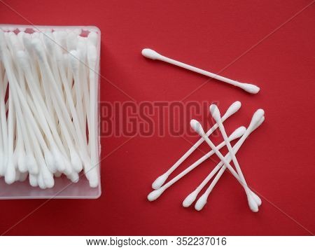 Flat Lay Composition With Cotton Swabs On Red Background. Top View Ear Sticks.
