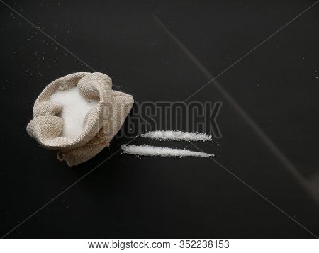 Sugar Looks Like Cocaine Divided Into Paths On A Black Background. Sugar Addiction Concept