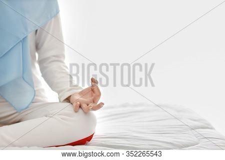 Close Up Young Asian Muslim Woman Hand Sitting On Bed And Enjoying Meditation. Beautiful Girl In Sle