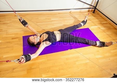 Sporty Young Caucasian Woman Doing Stretching Exercises Of Full Body Muscles Workout On Stretch Aero
