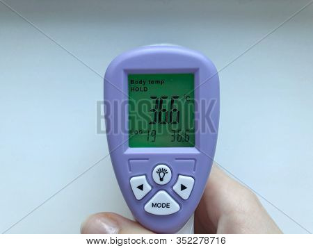 Electronic Thermometer In Hand. Is Used To Measure A Patients Temperature In A Hospital.