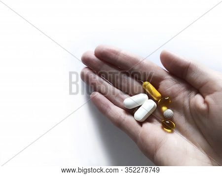 Different Vitamins In The Palm Of Your Hand.