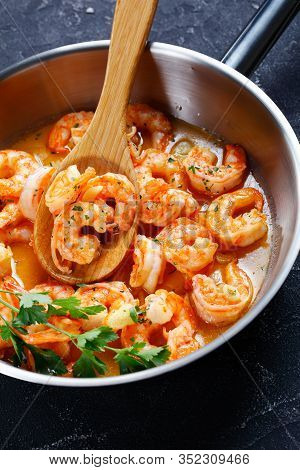 American Seafood Dish: Shrimp Scampi With Garlic And Butter Sauce Sprinkled With Parsley, On A Skill