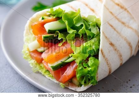 Wrap Sandwich, Roll With Fish Salmon And Vegetables. Grey Background. Close Up.