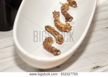 Dried Homemade Chicken Necks In White Bowl. Dog And Cat Chewy Jerky And Treats Made With Dehydratati
