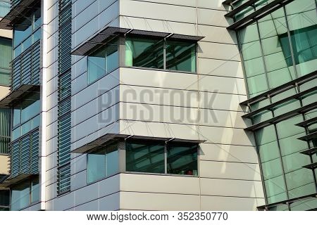 A View At A Straight Facade Of A Modern Building With A Dark Grey Facade. Dark Grey Metallic Panel F