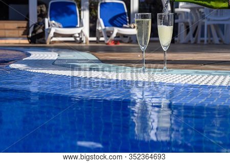 Pool Party With Two Glasses Of Bubbles White Champagne Or Cava Wine, Romantic Event On All Inclusive