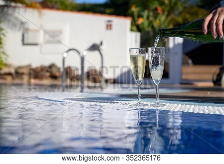 Pool Party With Two Glasses Of Bubbles White Champagne Or Cava Wine, Romantic Event On All Inclusive