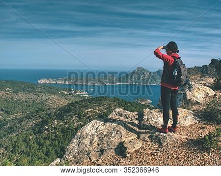 Traveler Woman Shadowing Eyes While Watching Blue Sea Bay Within Mountain Single Trail