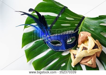 Purim, Carnival, Mardi Gras Festive Background With Carnival Mask, And Triangle Variety Cookies On L
