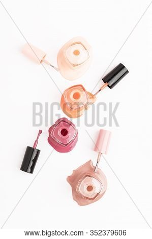 Open Unbranded Glass Bottle With Nail Polish. Poured Liquor Of Nail-varnish Isolated On White Backgr