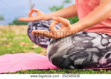 Lotus Pose. Close Up Gyan Mudra. Focus On One Hand. Yoga Outdoor. Young Woman Sitting On Yoga Mat, M