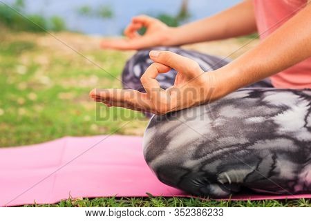 Lotus Pose. Close Up Gyan Mudra. Focus On One Hand. Yoga Outdoor. Young Woman Sitting On Yoga Mat, M