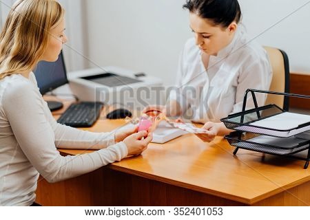 Sanitary Tampons Or Menstrual Cup. Young Woman Patient Talking With Female Gynecologist During The C