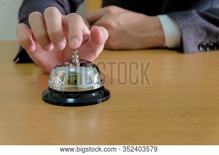 Men Business People With Suit Reaching His Hand And Finger To Ring A Reception Or Restuarant Bell On