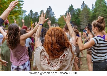 A Caucasian Woman With Ginger Hair And Fair Skin, Is Seen From The Rear Is Shallow Depth Of Field As