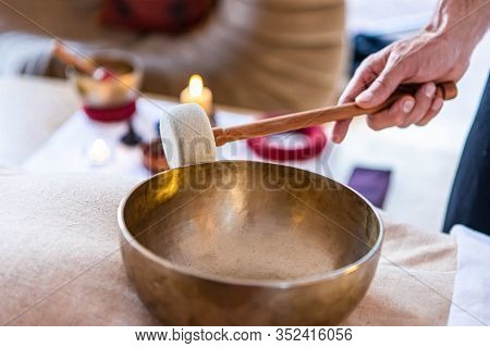 Massage Therapist Giving A Sound Massage With Tibetan Singing Bowl. Sound Therapy Used For Doing Spe