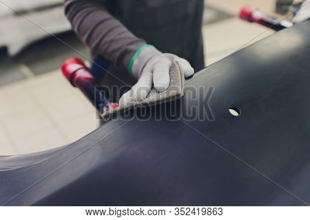Auto Mechanic Preparing The Car For Paint Job By Applying Polish With The Power Buffer Machine
