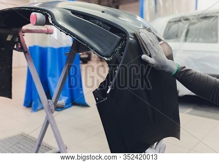 Auto Mechanic Preparing The Car For Paint Job By Applying Polish With The Power Buffer Machine