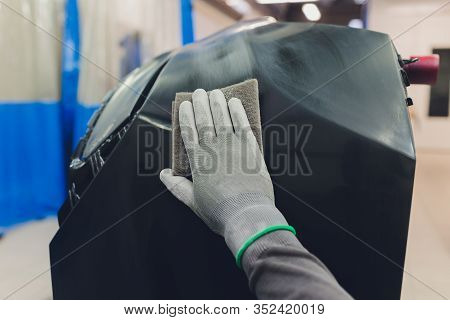 Auto Mechanic Preparing The Car For Paint Job By Applying Polish With The Power Buffer Machine