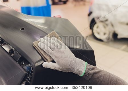 Auto Mechanic Preparing The Car For Paint Job By Applying Polish With The Power Buffer Machine