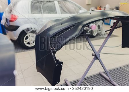 Auto Mechanic Preparing The Car For Paint Job By Applying Polish With The Power Buffer Machine