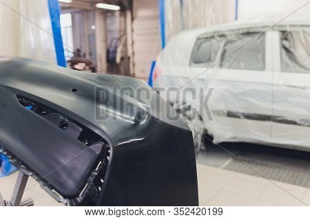 Auto Mechanic Preparing The Car For Paint Job By Applying Polish With The Power Buffer Machine