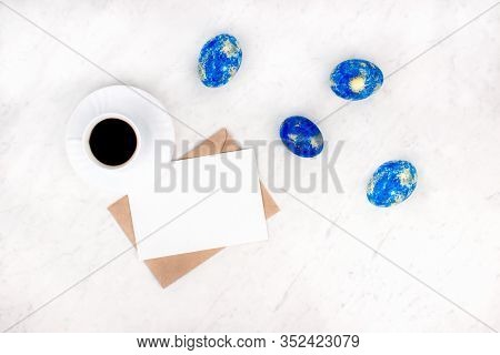 Modern Blue Golden Spring Easter Eggs With Envelope, Letter White Card, Cup Of Coffee Flat Lay On Ma