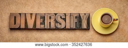 diversify  word abstract in vintage letterpress wood type with a cup of coffee against textured paper, investment strategy concept