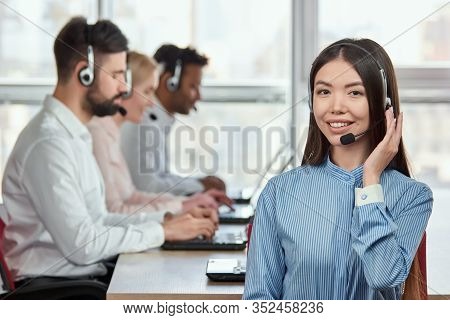 Korean Girl Portrait With Headset. Japaneese Young Woman Talking By Headset With Customers, Busy Off