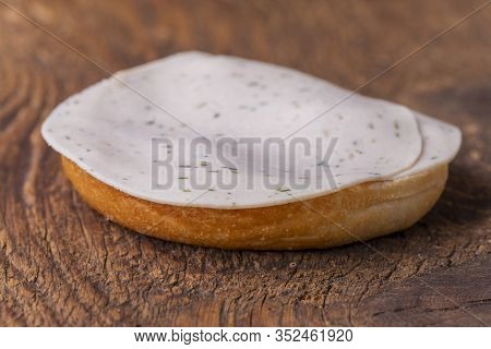 Bun On Wood With Sausage On Dark Wood