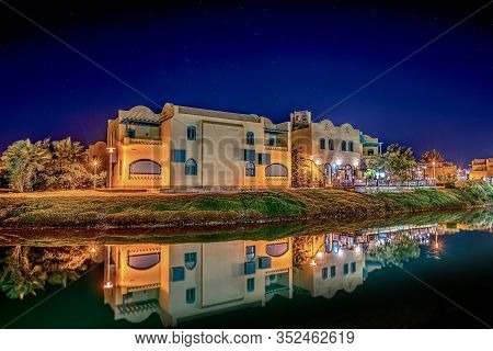 Egyptian Houses At The Side Of The Lagoon, Reflecting In The Water At Night, El Gouna, Egypt, Januar