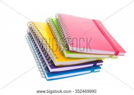 Stacked colorful notebooks isolated over white background
