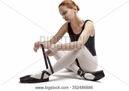 Sport Ideas. Portrait Of Tranquil Caucasian Professional Ballet Dancer In Body Suit  And Pointes Sho