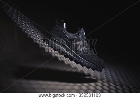 Black New Balance 574 Sneakers Shot Outdoor On Dark Industrial Background. Krasnoyarsk, Russia - Jan