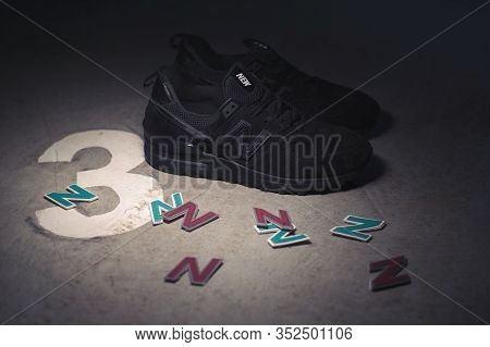 Black New Balance 574 Sneakers Shot Outdoor On Dark Industrial Background. Krasnoyarsk, Russia - Jan