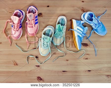 Stylish Adidas Iniki Running Shoes, Sneakers, Trainers In 3 Different Colors Shot On Wooden Backgrou