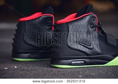 Legendary Nike Air Yeezy 2 Sport Shoes Shot Outdoor On Asphalt Road Line Background. Sport And Casua