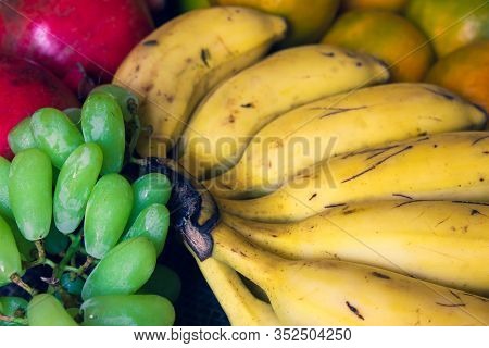 Green Grapes, Banana, Oranges And Pomegranate Fruit Together. Use For Fruit Concept.