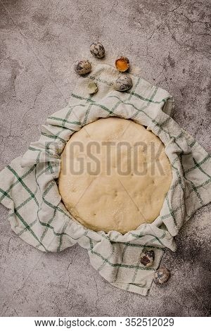 Fresh Yeast Mixed White Flour Dough For Bread. Round Bowl With A Towel On The Cement Table.
