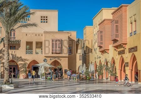 Children Playing And Parents Talking Amomg Colourful Egyptian Houses At The Marina Piazza In El Goun