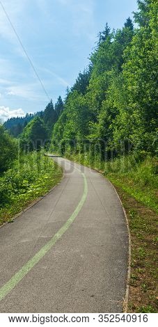Upwarding Asphalted Bystricka Cyklomagistrala Cycle-track With Trees Around And Blue Sky Near Zborov
