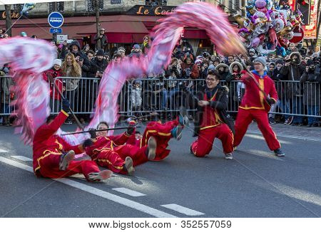 Paris, France-february 25,2018: Dynamic Image Of A Team Of Men Performing With The  Chinese Dragon D