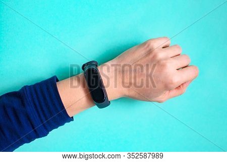 Classic Blue Fitness Tracker On A Girls Hand. Fitness Bracelet For Sports Training.