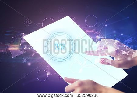 Hand holdig futuristic tablet with IVR inscription, modern technology concept