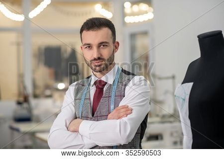 Male Fashing Designer Next To Dummy With Folded Hands