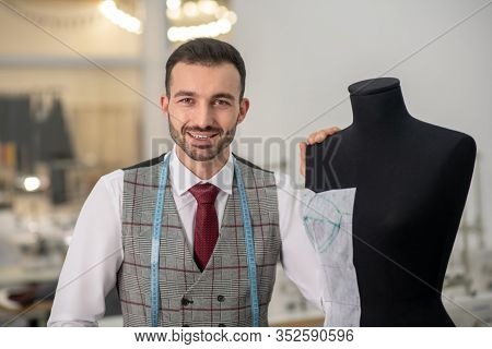 Male Fashing Designer With His Hand On Dummy