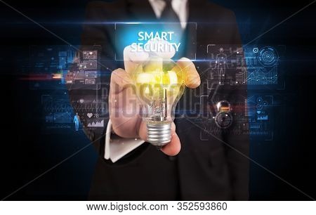 Businessman holding lightbulb with SMART SECURITY inscription, online security idea concept