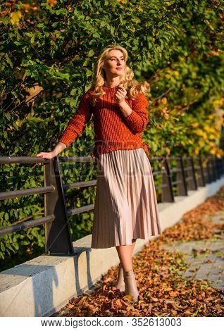 Autumn Woman. Girl Walk In Park. Girl In Corrugated Skirt And Sweater. Pleated Trend. Sunny Day With