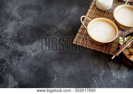 Makgeolli Rice Wine Is One Of The Oldest Korean Traditional Fermented Alcoholic Drinks On Dark Backg